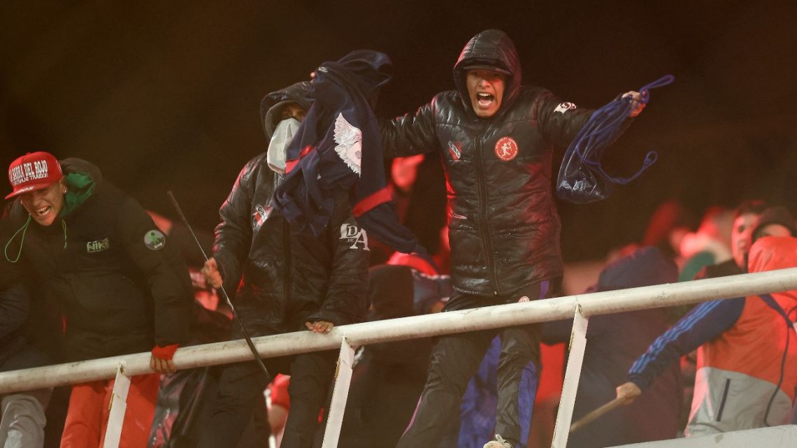 A fan of Independiente shouts during the interruption of the Copa Sudamericana round of 16 second leg football match between Argentina's Independiente and Chile's Universidad de Chile at the Libertadores de America stadium in Avellaneda, Buenos Aires province, Argentina on August 20, 2025