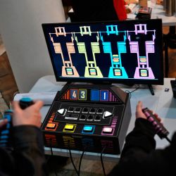 Men play a video game made from used and recycled electronic components during the 3rd Federal Cyberciruja Meeting in Buenos Aires, on August 16, 2025. 