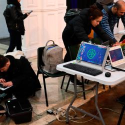 People use computers assembled from discarded and recycled electronic components during the 3rd Federal Cyberciruja Meeting in Buenos Aires, on August 16, 2025