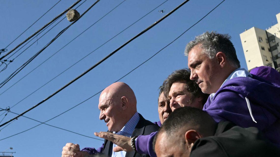 Protesters throw stones at President Javier Milei, his sister, Presidential Chief-of-Staff Karina Milei (unseen), La Libertad Avanza's candidate for national deputy in Buenos Aires Province, José Luis Espert, and other officials and candidates during a motorcade in Lomas de Zamora, Buenos Aires Province, Argentina, on August 27, 2025. 