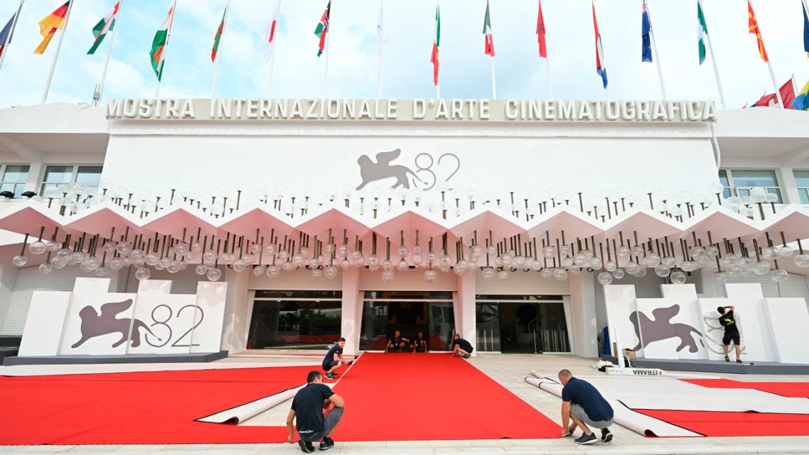Workers set the red carpet at the Palazzo del Cinema ahead of the opening ceremony of the 82nd Venice Film Festival at Venice Lido, on August 26, 2025. 