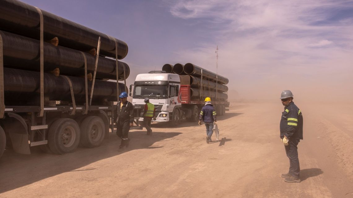 Workers inspect trucks arriving with pipes for the new construction of the Oldelval (Oleoductos del Valle) pipeline network to transport oil from Vaca Muerta at an YPF mining camp in the Province of Neuquén, Argentina, on March 13.