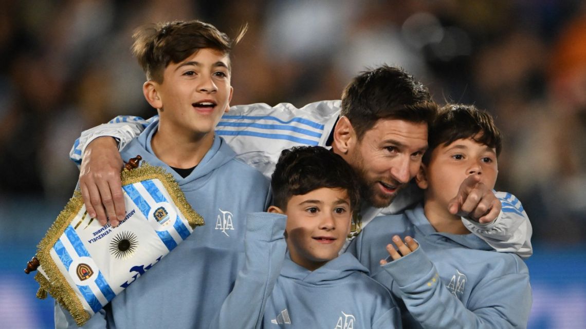 Argentina's skipper Lionel Messi hugs his sons ahead of the 2026 FIFA World Cup South American qualifiers football match between Argentina and Venezuela at the Mas Monumental stadium in Buenos Aires on September 4, 2025. 