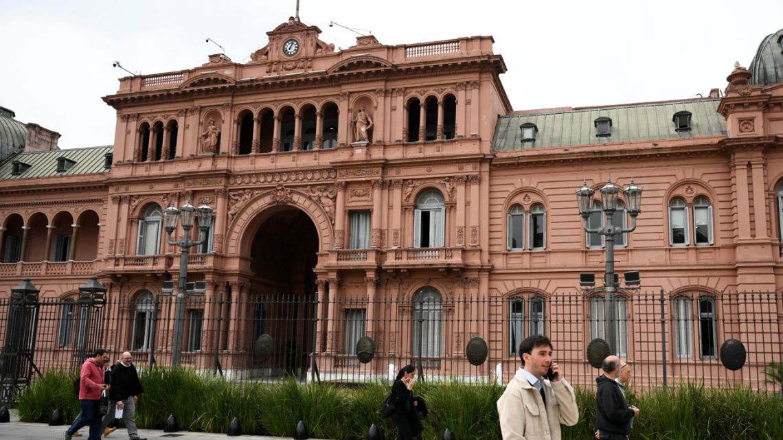 People walk past Casa Rosada presidential palace in Buenos Aires on September 8, 2025.