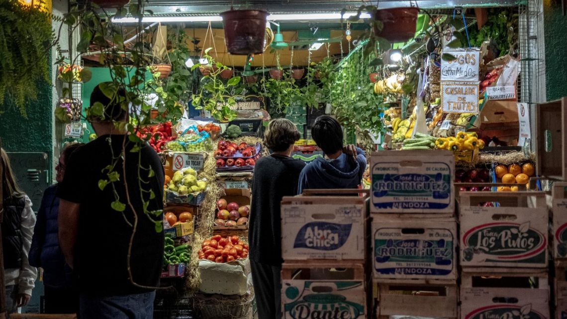 Shoppers browse produce at a grocery store in Buenos Aires.