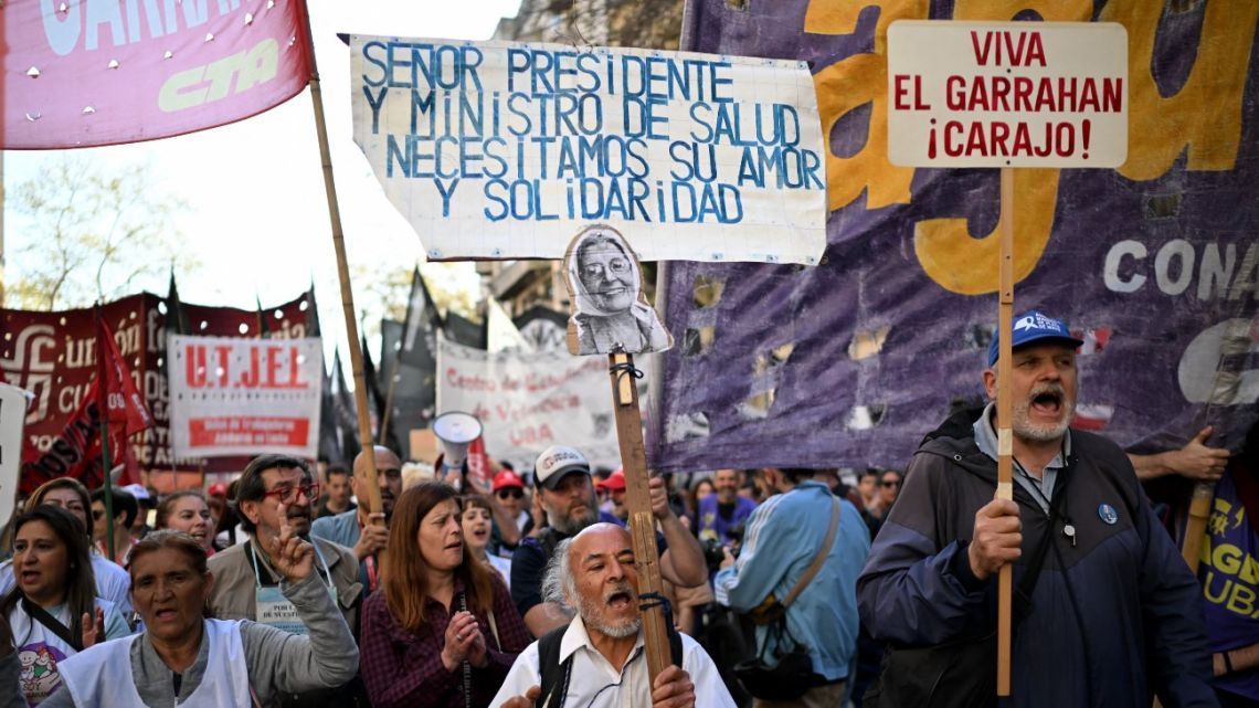 People attend a rally called by workers of the Garrahan paediatric hospital, universities, and unions in Buenos Aires on September 12, 2025. Doctors and nurses from Buenos Aires' main paediatric hospital marched this Friday alongside university students to protest President Javier Milei's vetoes of increased funding for these sectors as part of his austerity policy. 
