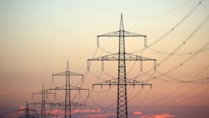 Electricity Pylons And Cables During Sunset