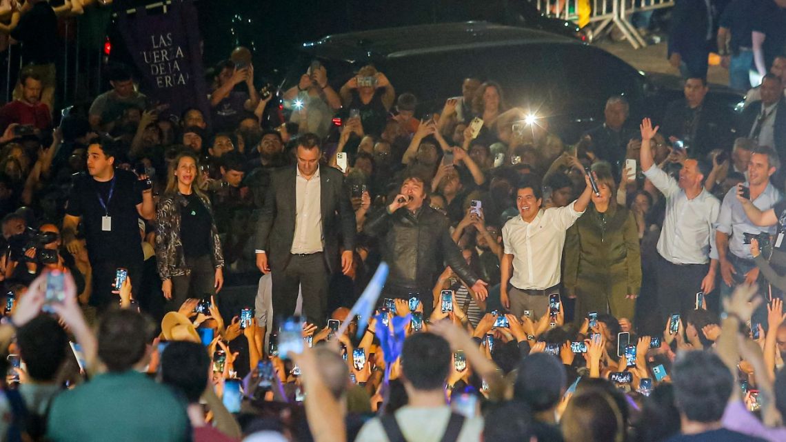 Javier Milei speaks next to Manuel Adorni and Karina Milei during an open-air political rally at Parque Sarmiento in Córdoba, Argentina on September 19, 2025. Argentine President Javier Milei blamed "political panic" for rattling markets on September 19, 2025, in the run-up to crucial midterm elections, sending the peso into a tailspin and hurting the country's sovereign risk. 