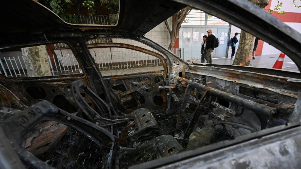 The burned car that allegedly transported Brenda del Castillo, Morena Verdi and Lara Gutiérrez is seen in front of a police station in La Tablada, on the outskirts of Buenos Aires, on September 26, 2025. 