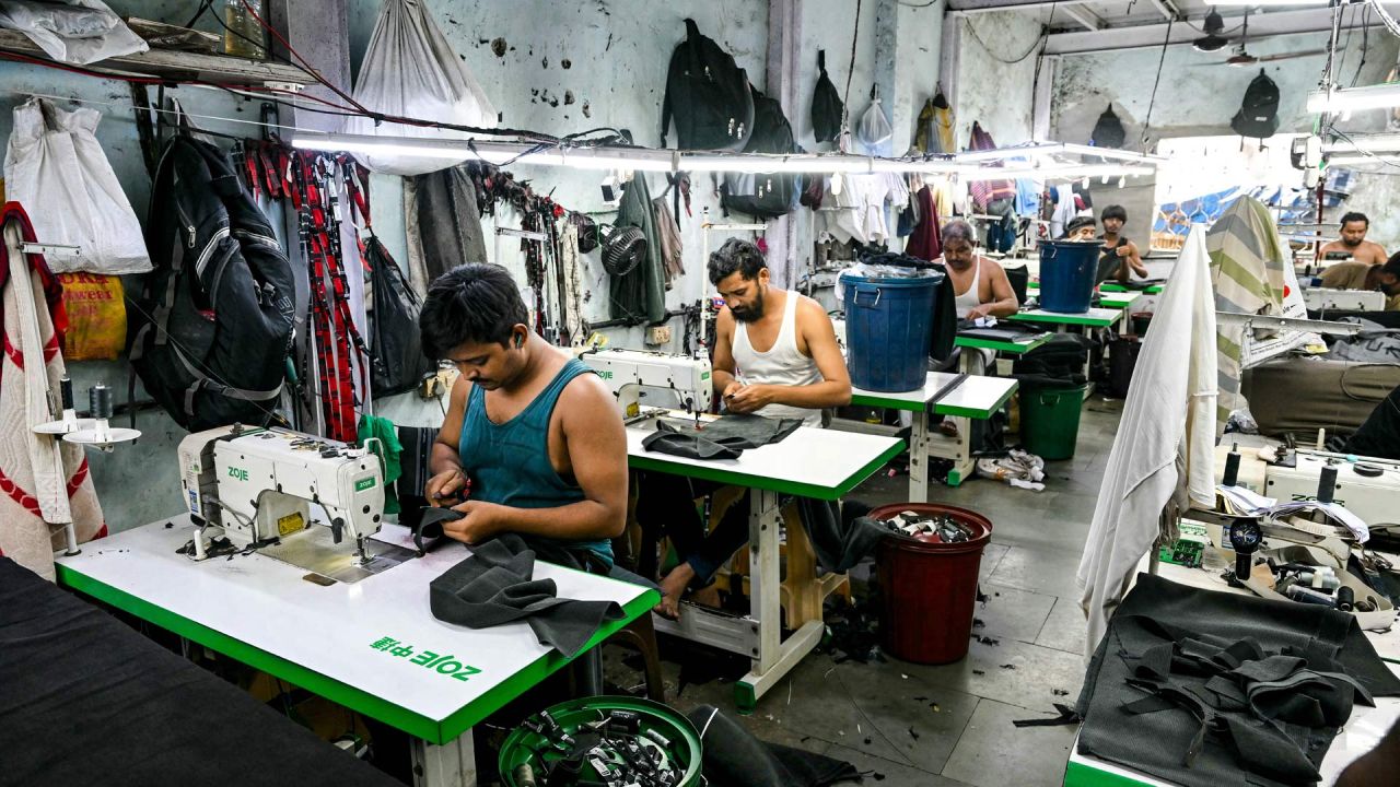 Esta fotografía muestra a sastres cosiendo ropa en una pequeña fábrica de ropa dentro de Dharavi, un asentamiento precario en Bombay. | Foto:Indranil Mukherjee / AFP