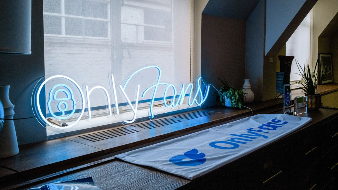 A neon OnlyFans Ltd sign in the window of the company's offices in London, UK.