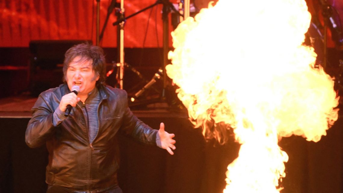 Argentina's President Javier Milei sings during the launch of his new book, "The Making of the Miracle," at the Movistar Arena in Buenos Aires on October 6, 2025. 