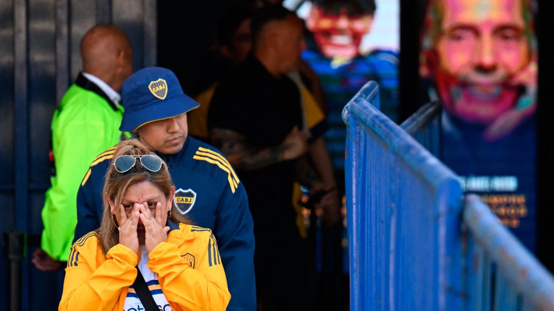 Football fans of late Argentine coach Miguel Ángel Russo leave La Bombonera stadium after paying tribute to him during his wake in Buenos Aires, on October 9, 2025.
