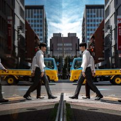 Los peatones se reflejan en el cristal mientras caminan por el distrito de Ginza de Tokio, Japón. | Foto:Philip Fong / AFP