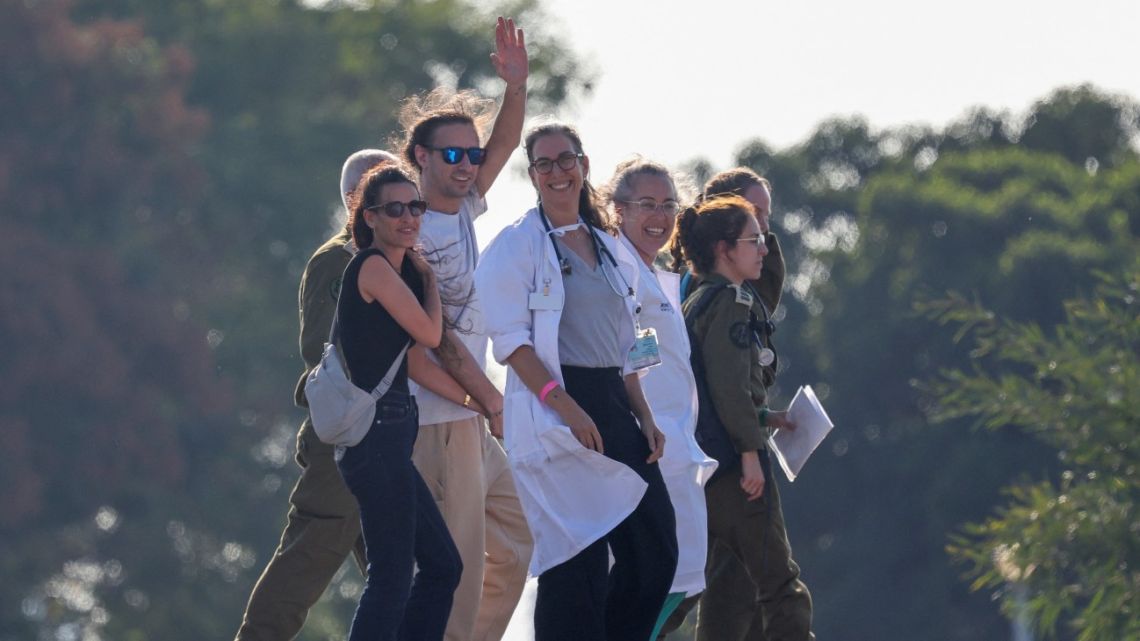 Israeli soldiers and medics accompany Ariel Cunio, formerly held hostage in Gaza since October 2023 by Palestinian militants, upon his arrival at the Sheba Tel-HaShomer Medical Centre in Ramat Gan on October 13, 2025,