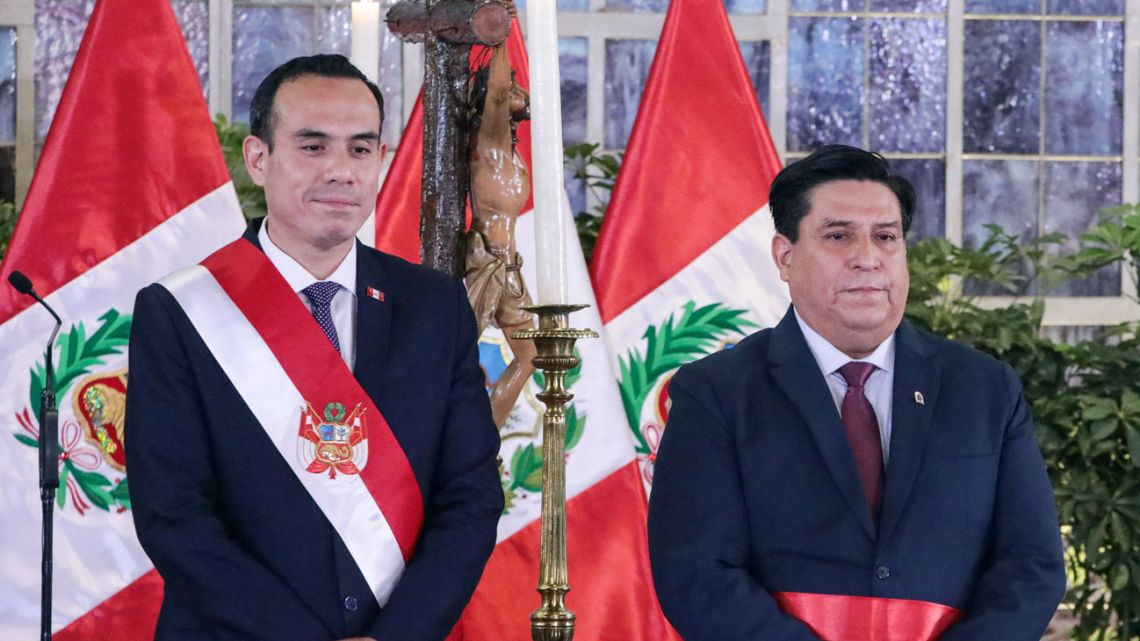 Peru's interim President José Jeri (left) poses for a picture after giving the oath of office to his new Interior Minister Vicente Tiburcio, during a ceremony at the Presidential Palace in Lima on October 13, 2025. 