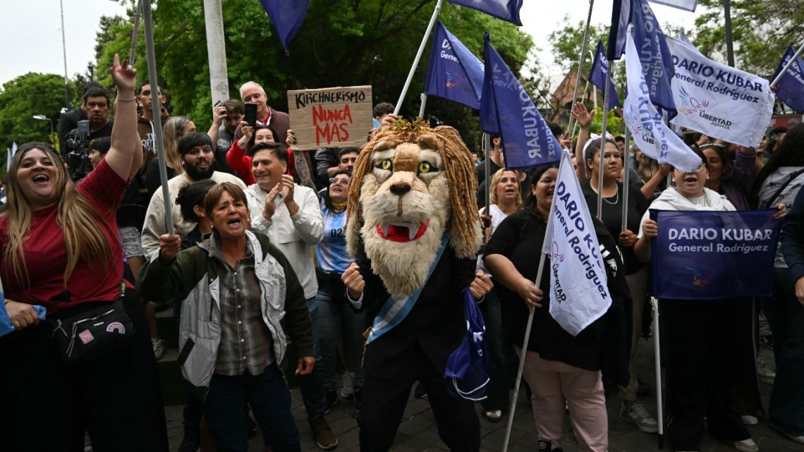 Supporters of Argentina's President Javier Milei demonstrate before his arrival for a campaign rally in Buenos Aires, on October 17, 2025.