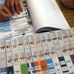 An election official works at a polling station during the national midterm legislative election in Buenos Aires on October 26, 2025. Argentines head to the polls for a midterm election that will determine whether President Javier Milei enters the second half of his term bolstered or diminished as economic troubles abound despite unprecedented US aid. Alejandro PAGNI / AFP