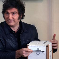 President Javier Milei poses for a picture before casting his vote at a polling station during the national midterm legislative elections in Buenos Aires on October 26, 2025.