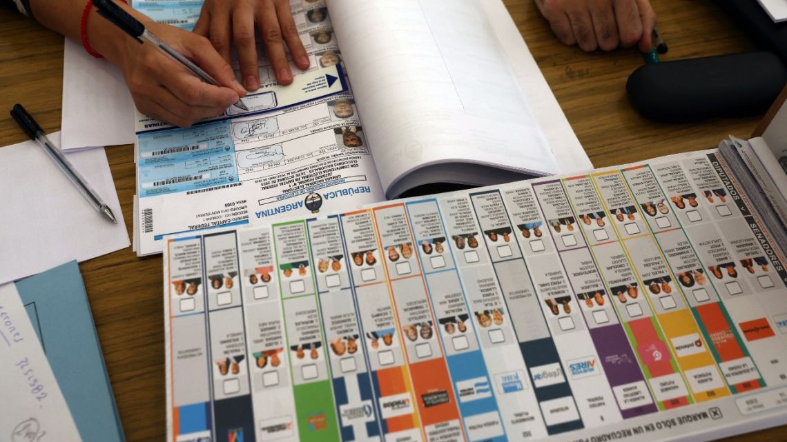 An election official works at a polling station during the national midterm legislative election in Buenos Aires on October 26, 2025. Argentines head to the polls for a midterm election that will determine whether President Javier Milei enters the second half of his term bolstered or diminished as economic troubles abound despite unprecedented US aid. Alejandro PAGNI / AFP