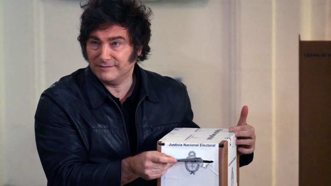 President Javier Milei poses for a picture before casting his vote at a polling station during the national midterm legislative elections in Buenos Aires on October 26, 2025. 