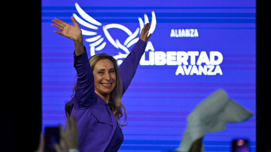 Presidential Chief-of-Staff Karina Milei waves to supporters as she celebrates at the ruling party's La Libertad Avanza headquarters following the results of the national midterm legislative election in Buenos Aires on October 26, 2025. 