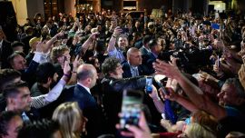 President Javier Milei greets supporters as he celebrates outside the ruling party's La Libertad Avanza headquarters after the results of the national midterm legislative election in Buenos Aires on October 26, 2025.