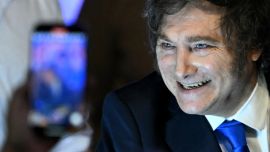 President Javier Milei greets supporters at the ruling party's La Libertad Avanza headquarters.