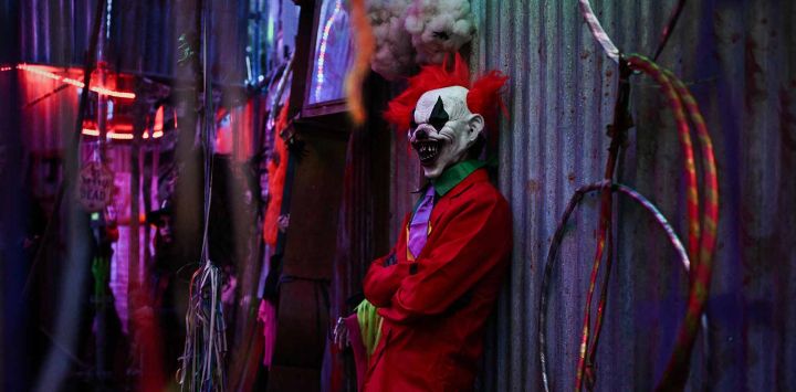 Un artista inspirado en el “Joker” se encuentra en una de las salas de atracción de casa embrujada, que cuenta con decoraciones de temática de terror para Halloween en Ambes. Philippe LOPEZ / AFP