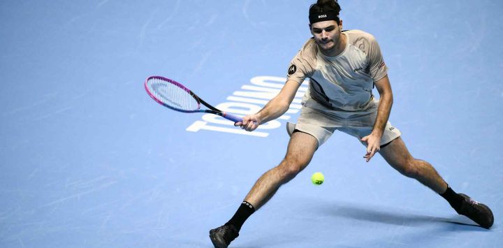 El estadounidense Taylor Fritz devuelve un golpe ante el italiano Lorenzo Musetti durante el torneo de tenis ATP Finals en Turín. Foto de Marco BERTORELLO / AFP
