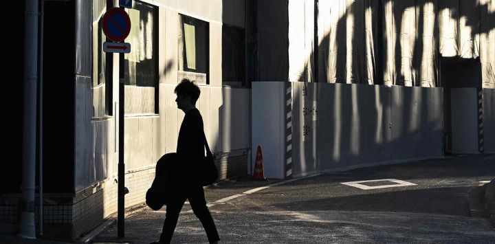 Un hombre camina por una calle en la zona de Yurakucho en Tokio. Foto de GREG BAKER / AFP