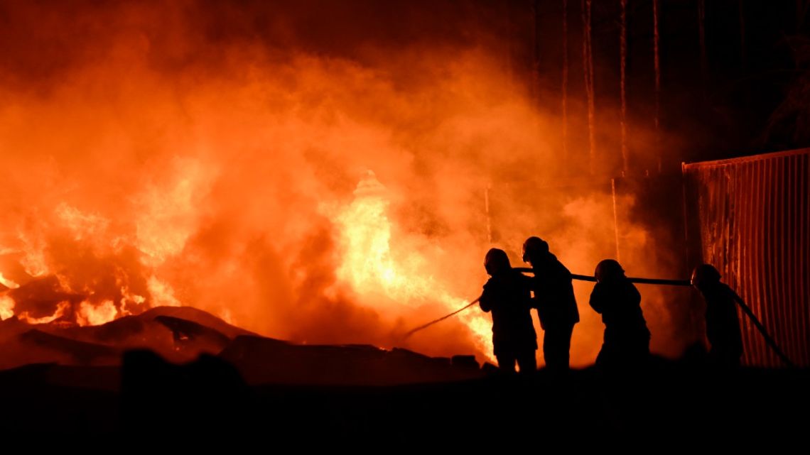 Firefighters work to extinguish a fire after an explosion in an industrial area of Ezeiza, Buenos Aires province, Argentina on November 15, 2025. Powerful explosions rocked an industrial area and ignited a fire south of Buenos Aires on the night of November 14, 2025, officials said, with at least 22 people sent to the hospital. 