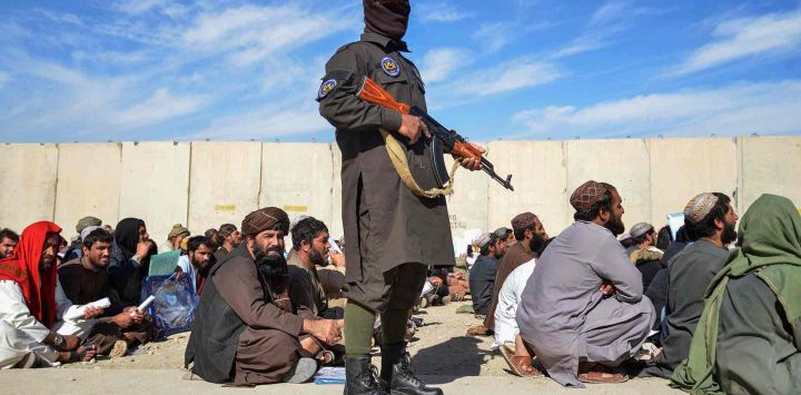 Un personal de seguridad armado talibán vigila junto a antiguos drogadictos que espera su liberación tras su recuperación en un centro de rehabilitación en el distrito de Daman. Foto de Sanaullah SEIAM / AFP