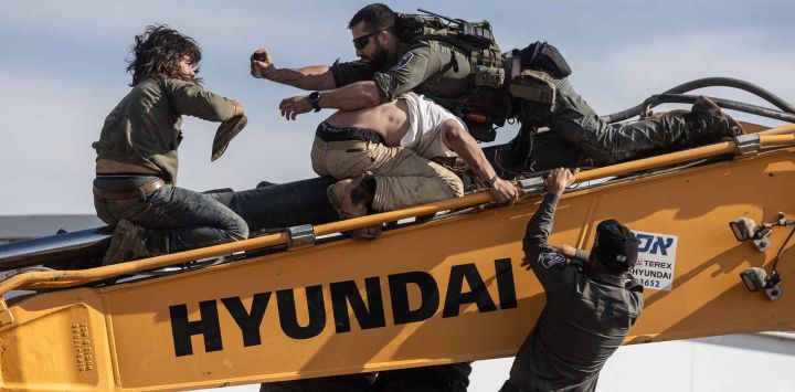 Fuerzas de seguridad israelíes se enfrentan con jóvenes colonos en un vehículo de tierra mientras evacuaban y demolían un asentamiento ilegal construido cerca del asentamiento judío de Metzad. Foto de Menahem KAHANA / AFP