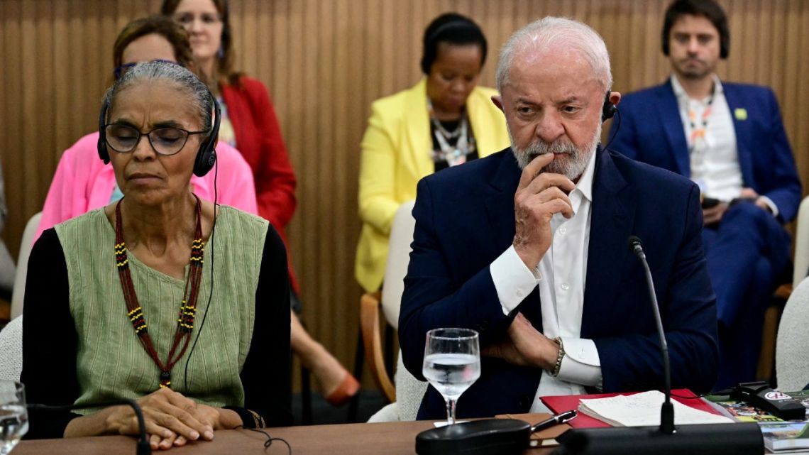 Brazil's President Luiz Inácio Lula da Silva and Environment Minister Marina Silva listen during a meeting with delegates from island nations at the COP30 UN Climate Change Conference in Belém, Pará State, Brazil, on November 19, 2025. 
