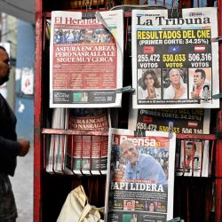 Un hombre camina frente a un quiosco que muestra las portadas de los periódicos en Tegucigalpa. Foto de Orlando SIERRA / AFP | Foto:AFP
