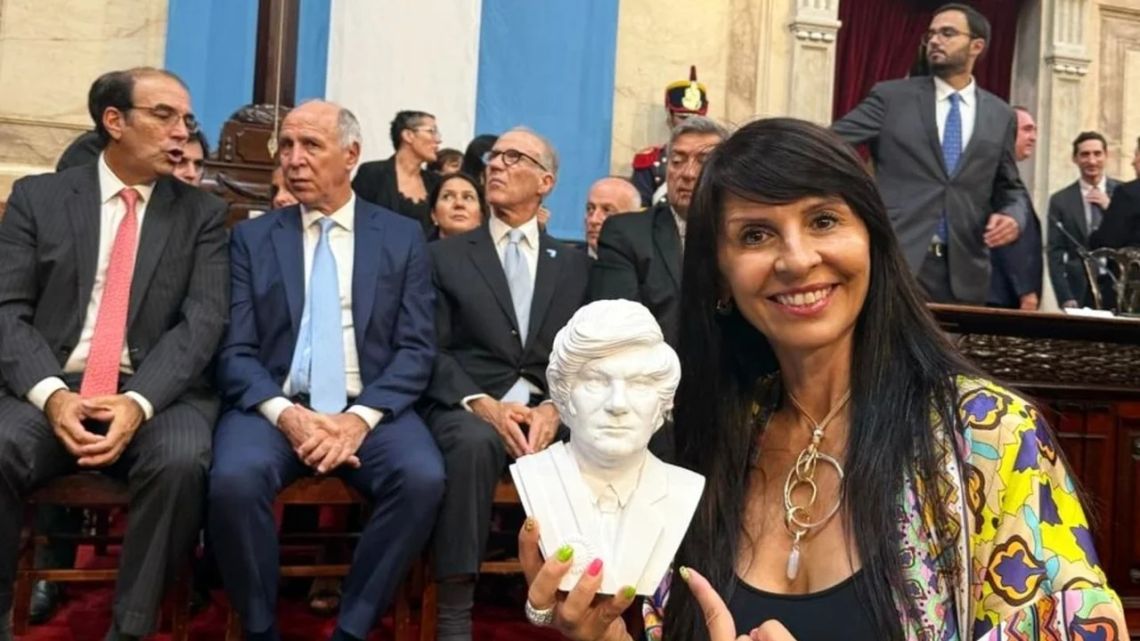 Lorena Villaverde, pictured in Congress holding a bust of President Javier Milei.