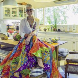 Descalza, sentada sobre la mesa y con una falda de Gino Bogani, Grace es pura frescura y elegancia.