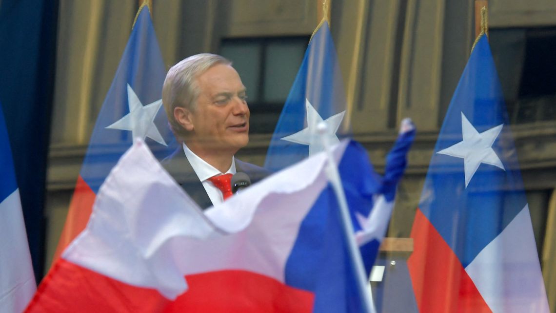 Chilean presidential candidate José Antonio Kast of the Partido Republicano delivers a speech behind bulletproof glass during his closing campaign rally in Concepción, Chile, on December 6, 2025. 