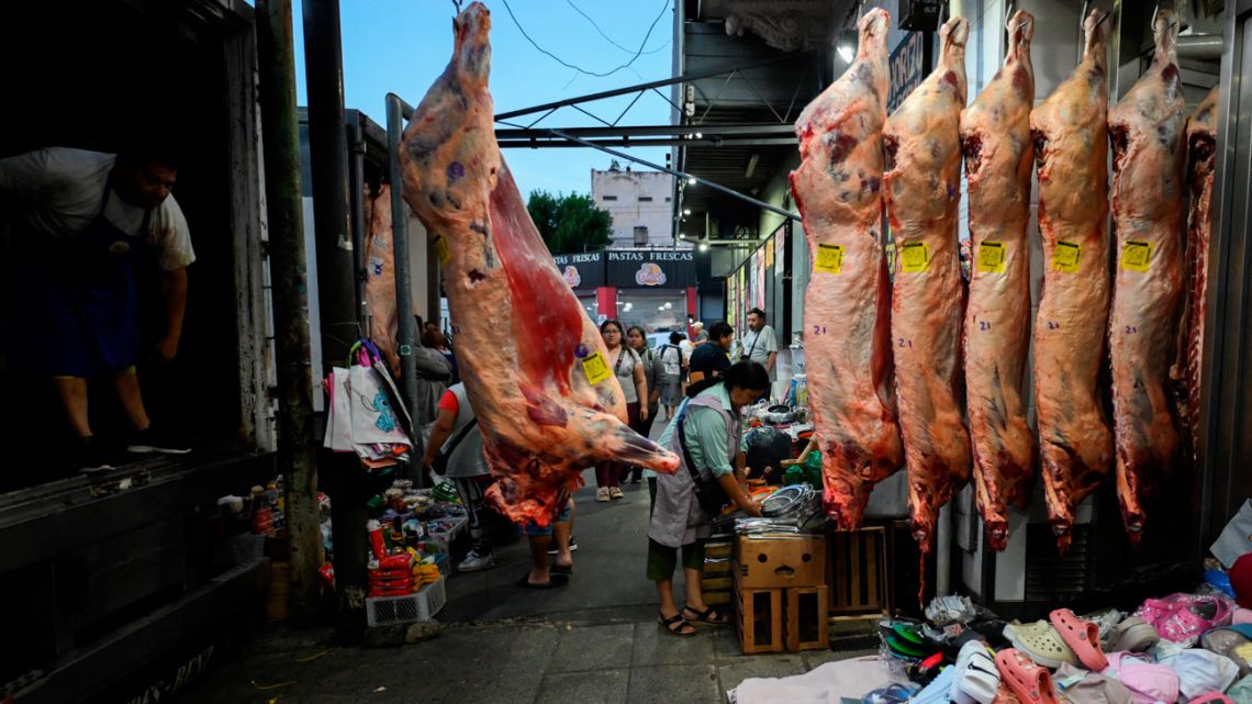 A worker unloads sides of beef from a truck at Mataderos neighbourhood in Buenos Aires, on December 5, 2025. 