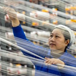Una trabajadora opera en el taller de una empresa textil, en Taizhou, en la provincia de Jiangsu, en el este de China. | Foto:XinhTang Dehong
