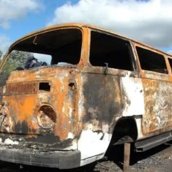 The burnt-out van used to escape.