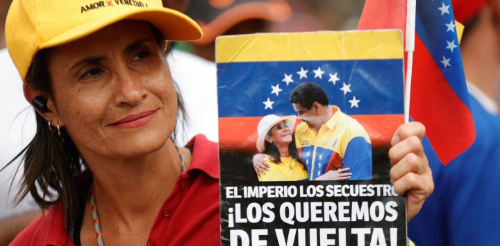 Una mujer sostiene una pancarta con la leyenda "Los queremos de vuelta" durante una manifestación en apoyo al depuesto presidente venezolano, Nicolás Maduro, y a su esposa, Cilia Flores, en Caracas.