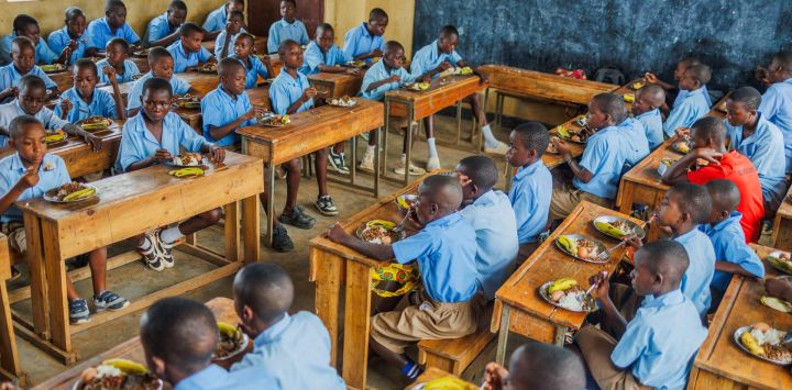 Imagen de niños almorzando en su salón de clases en una escuela, en el distrito de Bugesera, en la provincia Oriental, en Ruanda. Bajo un programa de apoyo infantil lanzado en 2023, los niños aquí reciben alimentos en escuelas para atender sus problemas de nutrición.