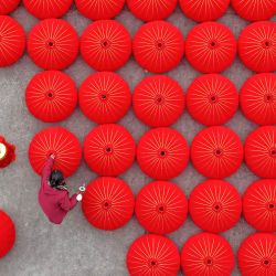 Imagen tomada con un dron de trabajadores elaborando linternas rojas en un taller de linternas, en el poblado de Hengxi de la ciudad de Taizhou, en la provincia de Zhejiang, en el este de China. El pueblo chino está ocupado preparando flores frescas, nudos chinos, coplas de primavera y otras necesidades tradicionales para celebrar el próximo Festival de la Primavera o el Año Nuevo chino. | Foto:Xinhua/Wang Huabin