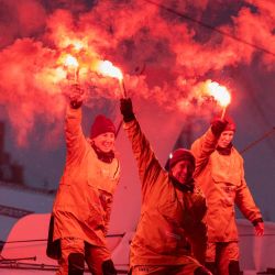 La capitana francesa Alexia Barrier y sus tripulantes celebran con bengalas encendidas su llegada al puerto de Brest a bordo del multicasco Ultim Idec Sport tras cruzar la meta del Trofeo Julio Verne, frente a la costa de Brest, Bretaña. La capitana francesa Alexia Barrier (The Famous Project) y sus seis tripulantes completaron frente a la costa de Brest, la primera vuelta al mundo sin escalas en un maxitrimarán con una tripulación exclusivamente femenina, según anunció su equipo. | Foto:FRED TANNEAU / AFP