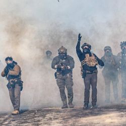 Un agente federal lanza una bomba de gas lacrimógeno contra los manifestantes mientras avanzan entre nubes de gas lacrimógeno durante los enfrentamientos tras el tiroteo mortal de un manifestante ese mismo día, en Minneapolis, Minnesota. Agentes federales de inmigración mataron a tiros a un hombre en Minneapolis, según informaron las autoridades. Se trata del segundo tiroteo mortal de un civil en la ciudad, lo que desató nuevas protestas e indignación por parte de las autoridades estatales. La muerte se produjo menos de tres semanas después de que la ciudadana estadounidense Renee Good fuera asesinada a tiros por un agente del Servicio de Inmigración y Control de Aduanas (ICE) que participaba en redadas para detener a migrantes indocumentados. | Foto:Kerem Yucel / AFP