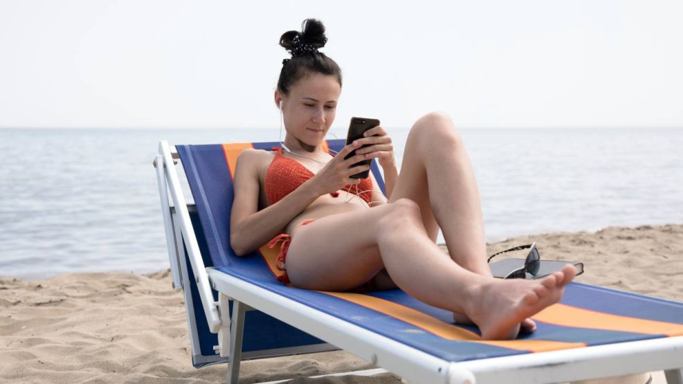 Con celular en la playa 07022026