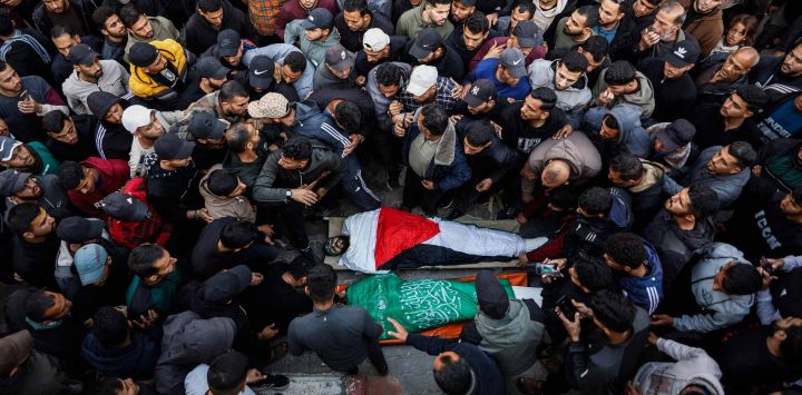 Familiares y amigos lloran sobre los cuerpos de hombres palestinos que fueron asesinados por un ataque israelí en la ciudad de Gaza. Foto de Omar AL-QATTAA / AFP