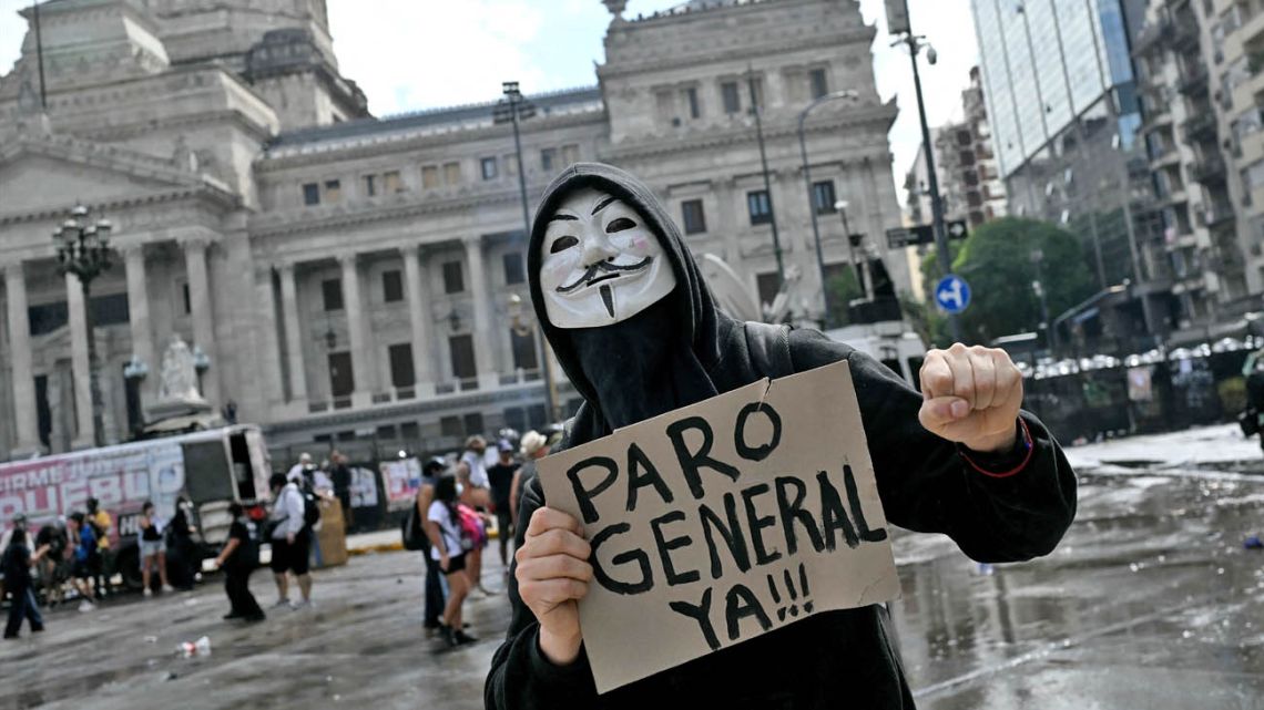 A demonstrator calls for a general strike in Argentina in response to President Javier Milei's labour reform bill.
